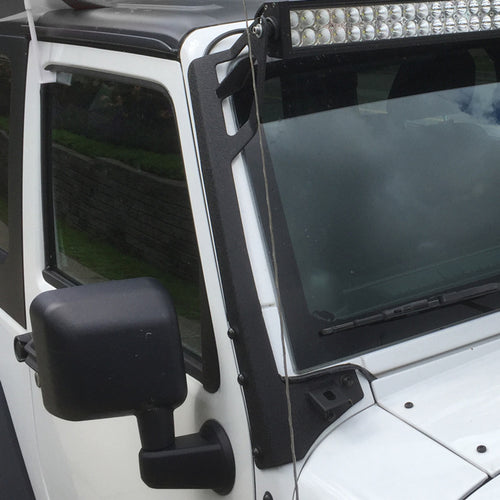 close-up of 2007–2018 Jeep Wrangler JK A-pillar light mount brackets installed on white Jeep Wrangler