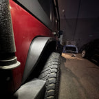 close-up of 2007–2018 Jeep Wrangler JK slim fender flares installed on red Jeep Wrangler