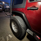 close-up of 2007–2018 Jeep Wrangler JK slim fender flares installed on red Rubicon Wrangler
