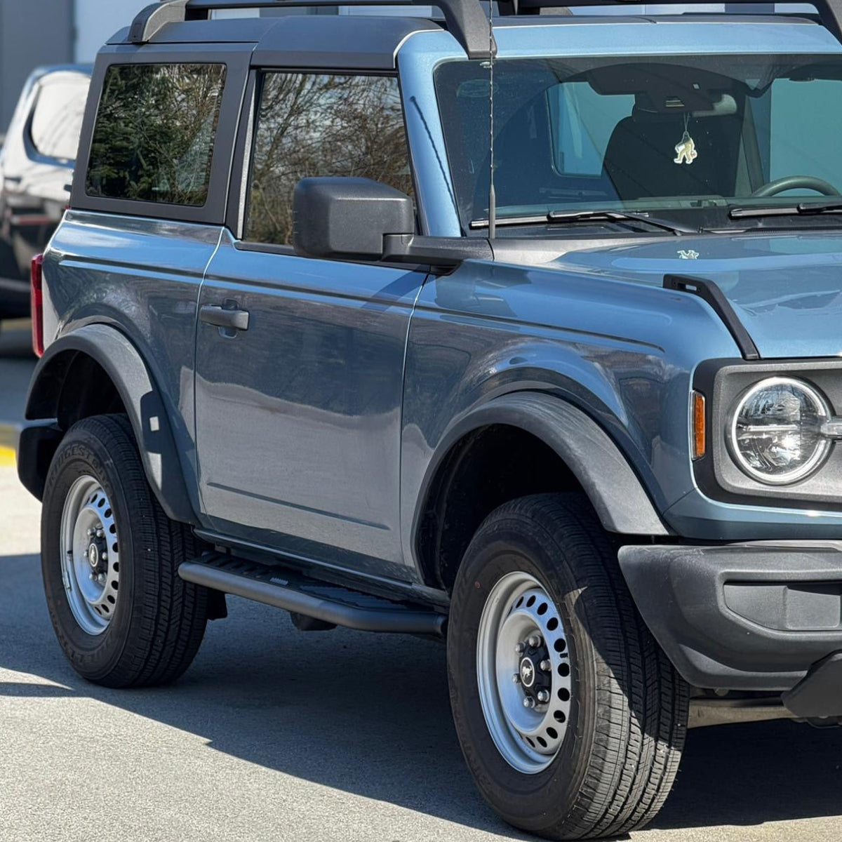 Running boards installed on blue 2021-2025 Ford Bronco 2 door textured black side steps