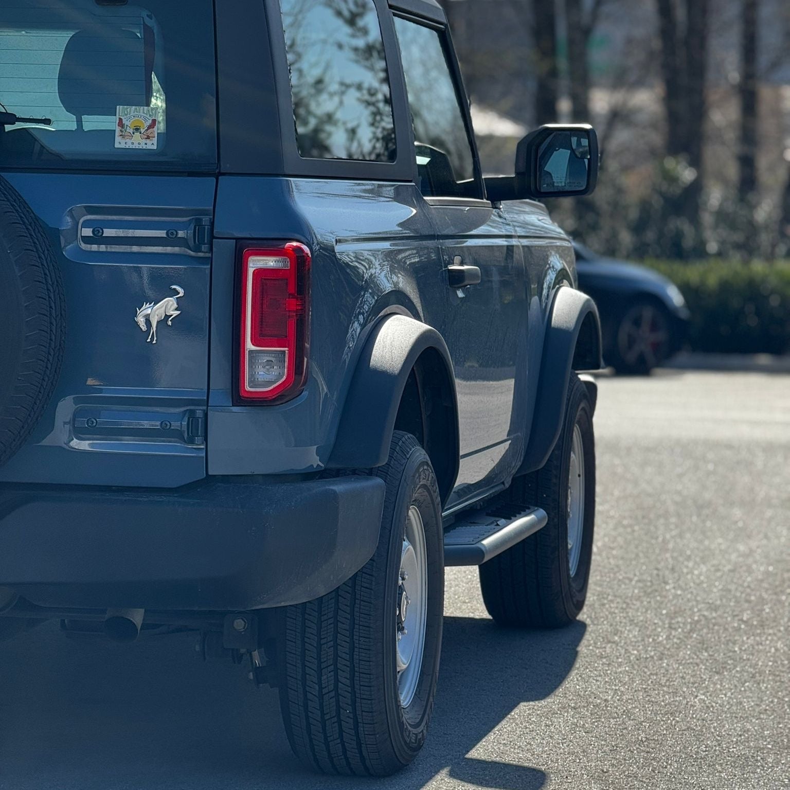 Rear view of running boards installed on blue 2021-2025 Ford Bronco 2 door textured black side steps